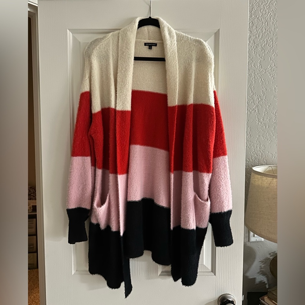 Long cardigan w/ pockets. Color blocking, red-pink-cream-black. Gently used